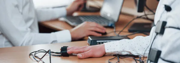 doctor performs electromyography on patient's hand